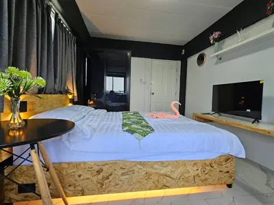 a bedroom with a large bed with a pink flamingo on it at Irich Residence Theparak S407 Bts-Chang Erawan 2kms in Ban Khlong Hua Sakae