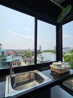 a kitchen counter with a sink and a window at Irich Residence Theparak S407 Bts-Chang Erawan 2kms in Ban Khlong Hua Sakae