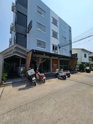 a group of motorcycles parked in front of a building at Irich Residence Theparak S407 Bts-Chang Erawan 2kms in Ban Khlong Hua Sakae