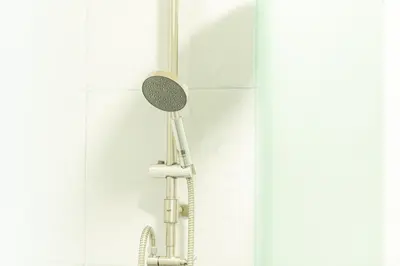 a shower with a shower head in a bathroom at GL Sport Club Serviced Residence in Bangkok
