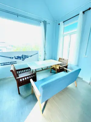 a dining room with a table and chairs and a large window at Setthisin Art Boutique House,Iconsiam,BTS Thonburi in Godown