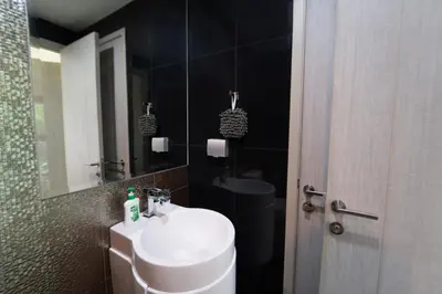 a bathroom with a white sink and a mirror at 5 Star Sukhumvit Condo Infinity Pool Gym Sauna in Bangkok