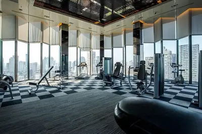a gym with a checkered floor and large windows at 5 Star Sukhumvit Condo Infinity Pool Gym Sauna in Bangkok