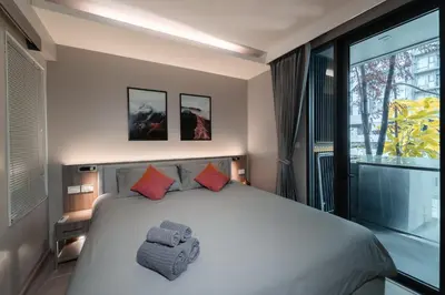 a bedroom with a large bed and a large window at 5 star Luxurious 1BD apt King Bed Thong Lor in Bangkok