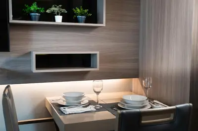 a table with plates and wine glasses on a table at 5 star Luxurious 1BD apt King Bed Thong Lor in Bangkok