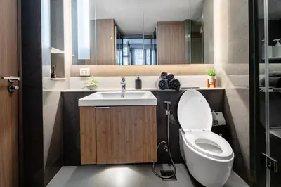 a bathroom with a toilet and a sink at 5 star Luxurious 1BD apt King Bed Thong Lor in Bangkok