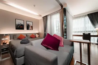 a living room with a bed and a couch at 5 star Luxurious 1BD apt King Bed Thong Lor in Bangkok