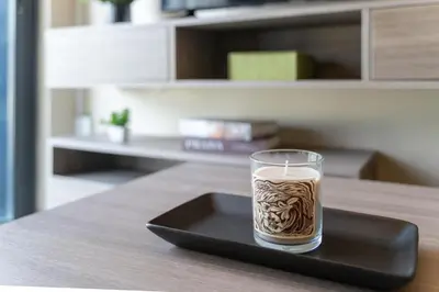 a glass of coffee on a black tray on a table at Luxury 2BR with Sky Pool & Gym Near BTS Thong lo in Bangkok