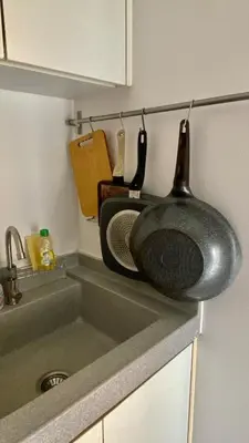 a kitchen sink with a pan on the counter at Cozy Entire Apartment place in Ban Khlong Samrong