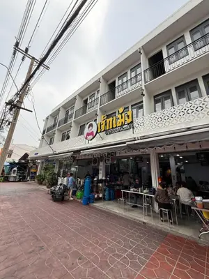 a building with people sitting at tables in front of it at GM6 - Samyan 4floors, 4mins walk to Bantadtong in Bangkok