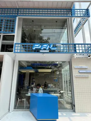 a building with people sitting at a table inside at GM6 - Samyan 4floors, 4mins walk to Bantadtong in Bangkok