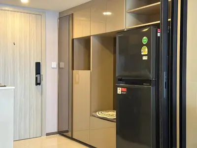 a kitchen with a black refrigerator in a room at Standardized at City View Condo near BTS Ratchathewi in Bangkok