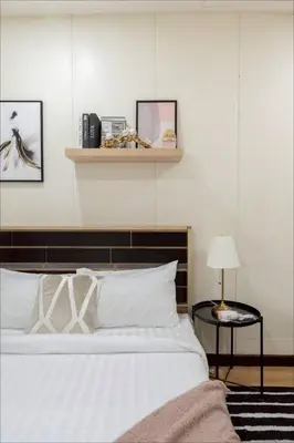 a bedroom with a bed and a table with a lamp at GM7 - Private House Downtown 2mins walk to metro in Bangkok