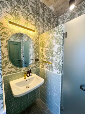 a bathroom with a sink and a mirror at Nara Poshtel Sathorn in Bangkok