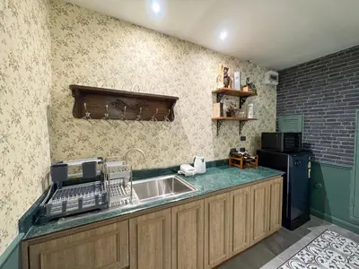 a kitchen with a sink and a microwave at Nara Poshtel Sathorn in Bangkok