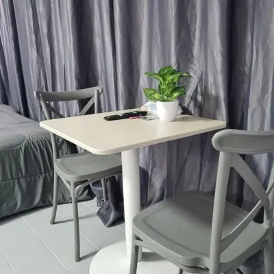 a white table with a plant and two chairs at Popular Muang Thong Condo, Building T9, Floor 8, Room 20 in Ban Bang Phang