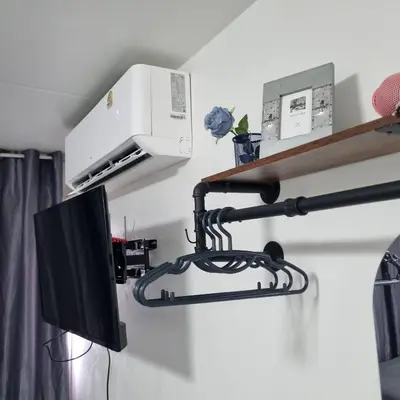 a kitchen with a microwave and a television on a wall at Popular Muang Thong Condo, Building T9, Floor 8, Room 20 in Ban Bang Phang