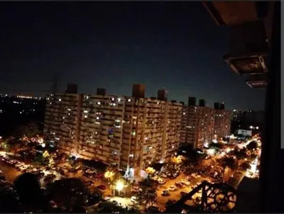 a large building with a parking lot at night at Popular Muang Thong Condo, Building T9, Floor 8, Room 20 in Ban Bang Phang