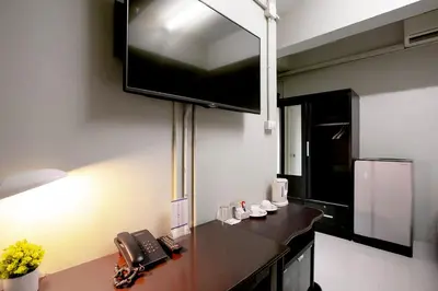 a kitchen with a counter with a tv on the wall at Annex Lumpini Bangkok in Bangkok
