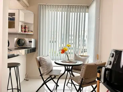 a kitchen with a table and chairs and a window at 2 mins to SRT I Urban Hideaway near Park in Bangkok