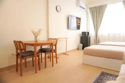 a bedroom with a table and chairs and a bed at Buddy House in Chinatown - Private Rooms Walk to MRT in Bangkok