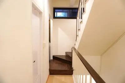 a staircase in a house with white walls and wooden floors at Buddy House in Chinatown - Private Rooms Walk to MRT in Bangkok