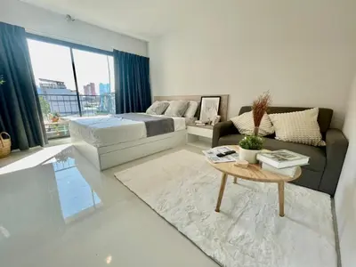 a bedroom with a bed and a couch and a table at Cozy stay! Near Chatuchak Market 814 in Bangkok