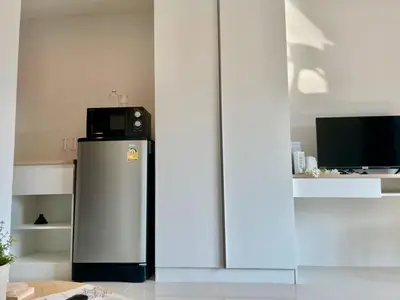 a refrigerator with a microwave on top of it at Cozy stay! Near Chatuchak Market 814 in Bangkok