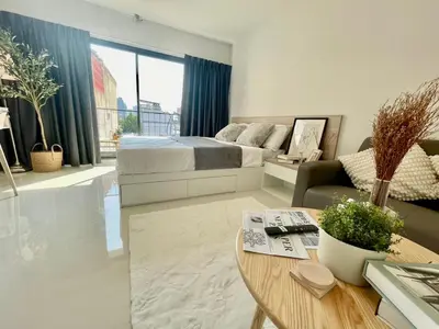 a living room with a bed and a table at Cozy Stay! Near Chatuchak Market 816 in Bangkok