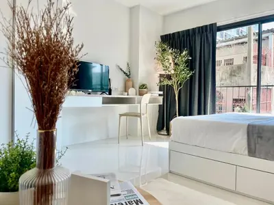 a bedroom with a bed and a desk with a tv at Cozy Stay! Near Chatuchak Market 816 in Bangkok