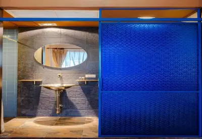 a blue shower door in a bathroom with a sink at Diamond House Khaosan in Bangkok