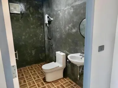 a bathroom with a toilet and a sink at Diamond House Khaosan in Bangkok