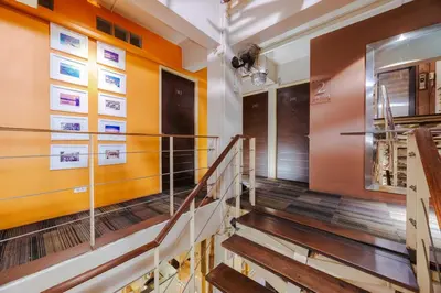 a staircase in a building with orange walls at Diamond House Khaosan in Bangkok
