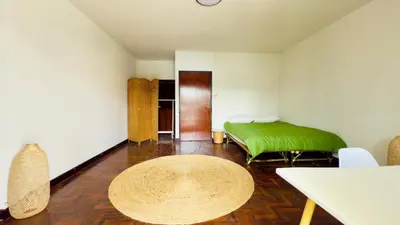 a room with a green bed and a table at Creative Bangkok Balcony in Sathani Bang Khen