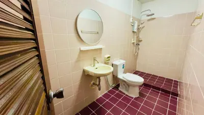 a bathroom with a toilet and a sink and a mirror at Creative Bangkok Balcony in Sathani Bang Khen
