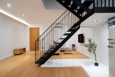 a living room with a staircase in a house at Townhouse in Khet Phayathai - Ari in Bangkok
