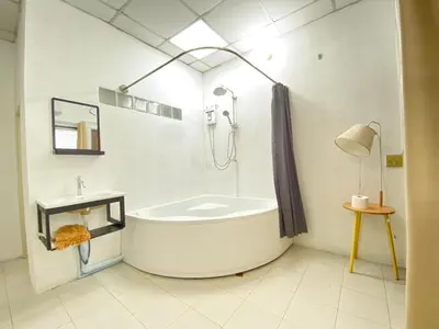 a white bathroom with a tub and a sink at Cheap house 7min next to BTS Kasetsart , 5 bedroom in Ban Yang