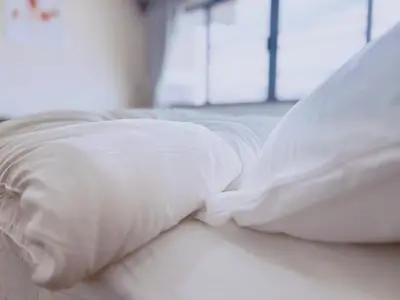 two white pillows sitting on top of a bed at 55sqm Hispeed LAN WiFi workplace 24h maxvalu in Bangkok
