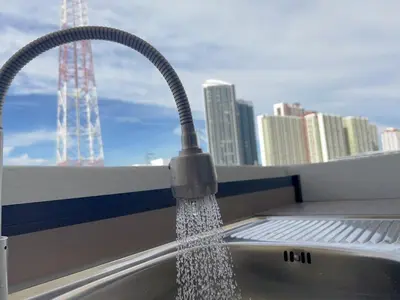 a kitchen sink with water pouring from a faucet at 55sqm Hispeed LAN WiFi workplace 24h maxvalu in Bangkok