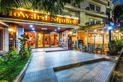a restaurant in front of a building at night at Dancenter Howard Square Boutique Hotel in Bangkok