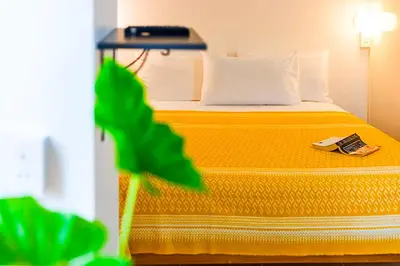 a hotel room with a bed with a book on it at Dancenter Howard Square Boutique Hotel in Bangkok