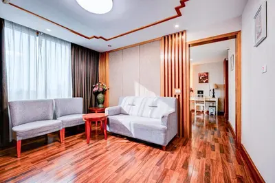 a living room with two chairs and a table at Dancenter Bangkok Travellers Hotel in Bangkok