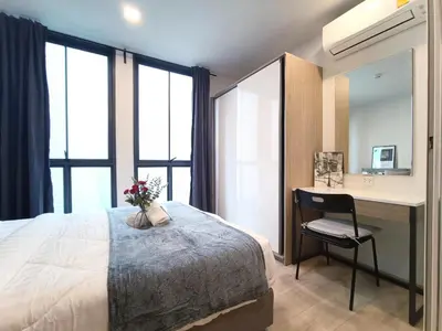 a bedroom with a bed and a desk with a chair at Amazing 1 bedroom 2 mins walk BTS On Nut in Bangkok