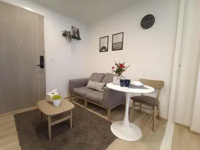 a living room with a couch and a table at Amazing 1 bedroom 2 mins walk BTS On Nut in Bangkok