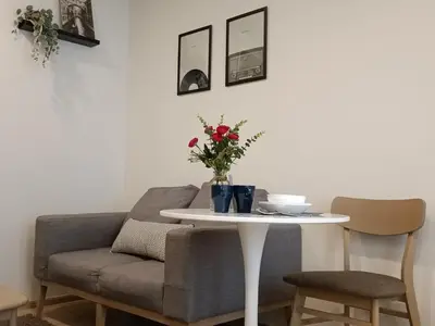 a living room with a table and a couch at Amazing 1 bedroom 2 mins walk BTS On Nut in Bangkok