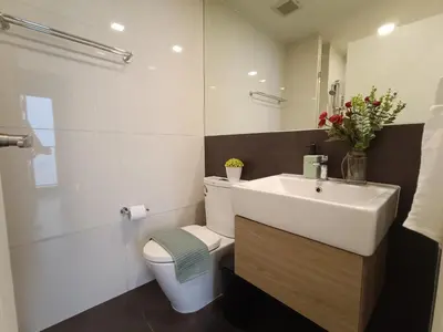 a white bathroom with a toilet and a sink at Amazing 1 bedroom 2 mins walk BTS On Nut in Bangkok