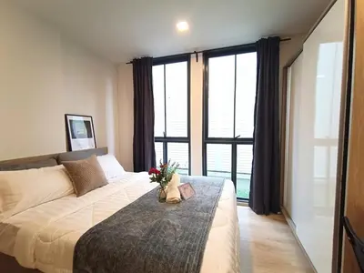 a bedroom with a large bed and a large window at Amazing 1 bedroom 2 mins walk BTS On Nut in Bangkok