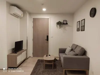 a living room with a couch and a tv at Amazing 1 bedroom 2 mins walk BTS On Nut in Bangkok
