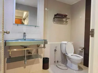 a bathroom with a toilet and a sink at Dancenter VResotel in Bangkok