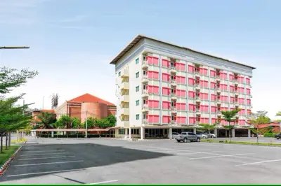 a large building with a parking lot in front of it at Dancenter VResotel in Bangkok